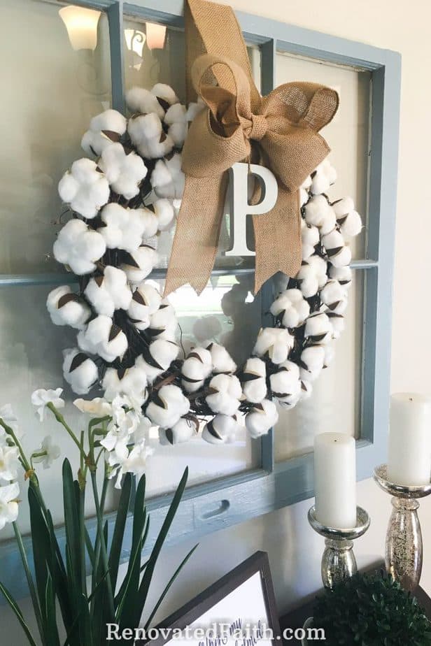 DIY Cotton Wreath for Less Than $10 – This tutorial shows you how to make a cotton boll wreath for your front door, mantel or anywhere in your home. Cotton wreaths are such a fun to include in your fall décor, spring decor or for the holidays. Include a burlap bow to give it a more rustic, farmhouse look even Joanna Gaines would be proud of. #fixerupper #farmhouse #easydiy #cotton #wreath #tutorial #diy #budgetdecor