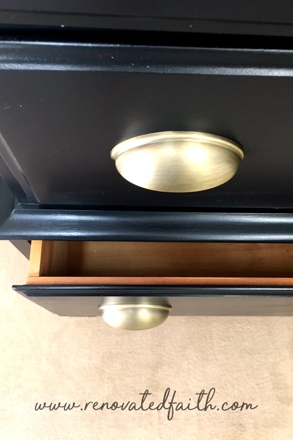 black dresser with gold hardware