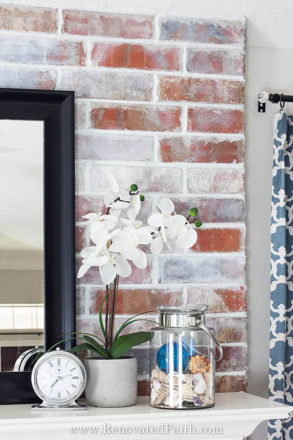 How to Whitewash a Fireplace – Get the look of the German Smear or  “Mortar wash”  with paint and this easy tutorial.  Update your brick fireplace or accent walls with this DIY technique that shows you how to paint with low budget products for a farmhouse look.  #easydiy #homedecor