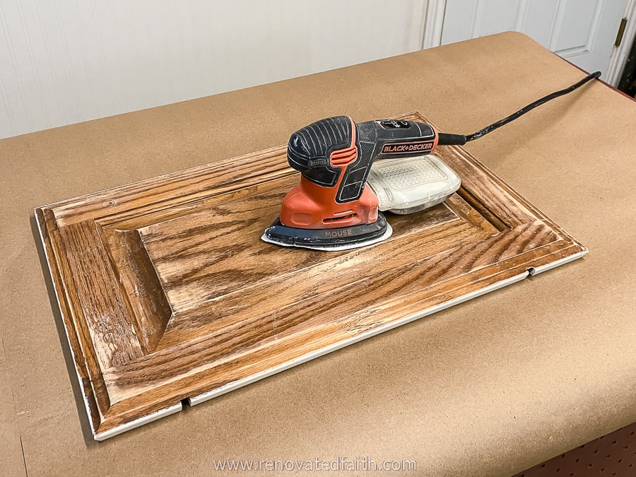 black and decker sander on cabinet door