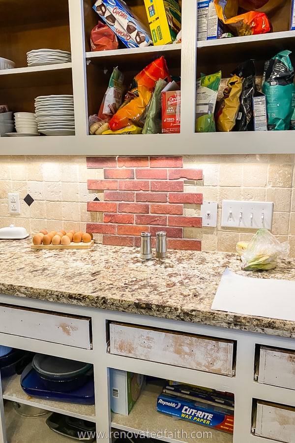 red brick backsplash panel over old tile