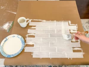 painting backsplash panel white with a brush