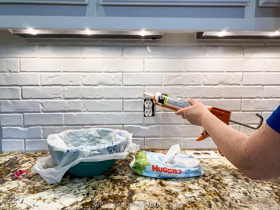 caulking the edges of the brick panels