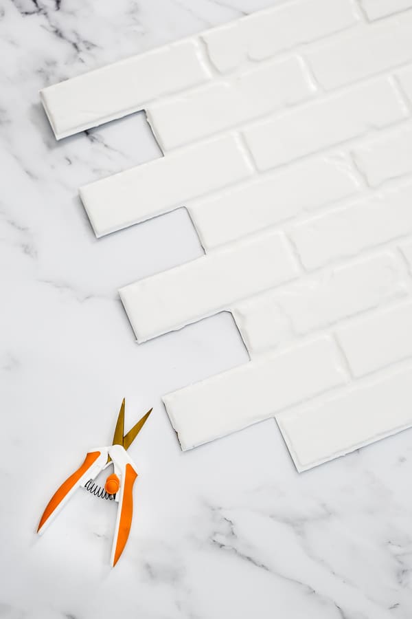 white brick panel for backsplash and scissors