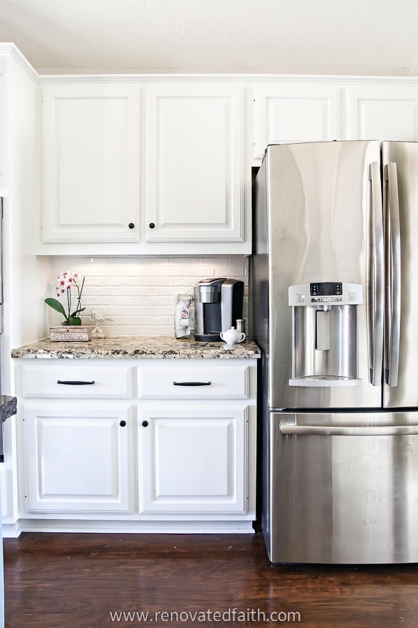 white paint cabinets by refrigerator