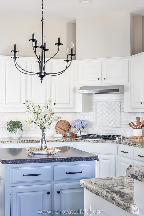 kitchen with blue island and flowers