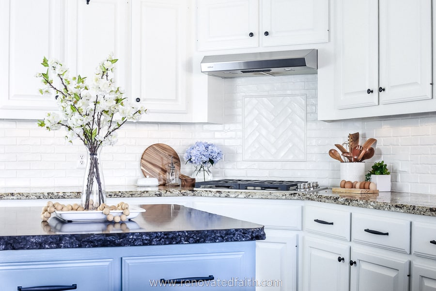 white kitchen with blue island