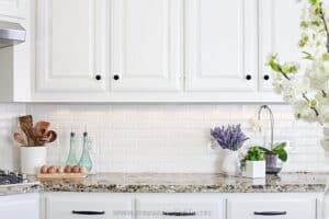 close up image of white backsplash and cabinets