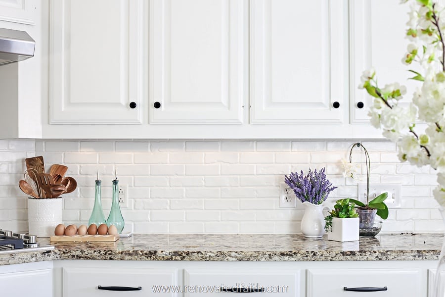 close up image of white backsplash and cabinets