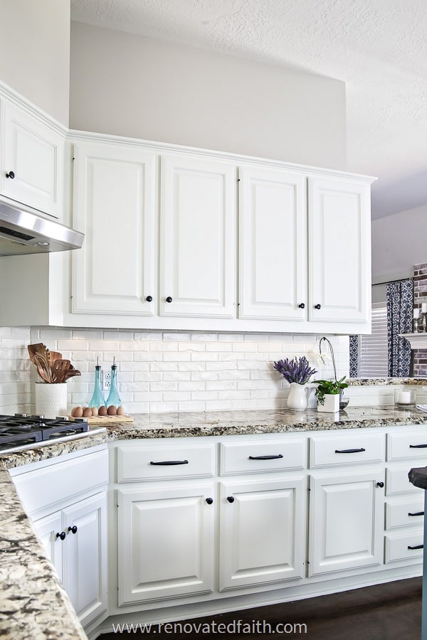 alabaster white kitchen cabinets and white brick backsplash