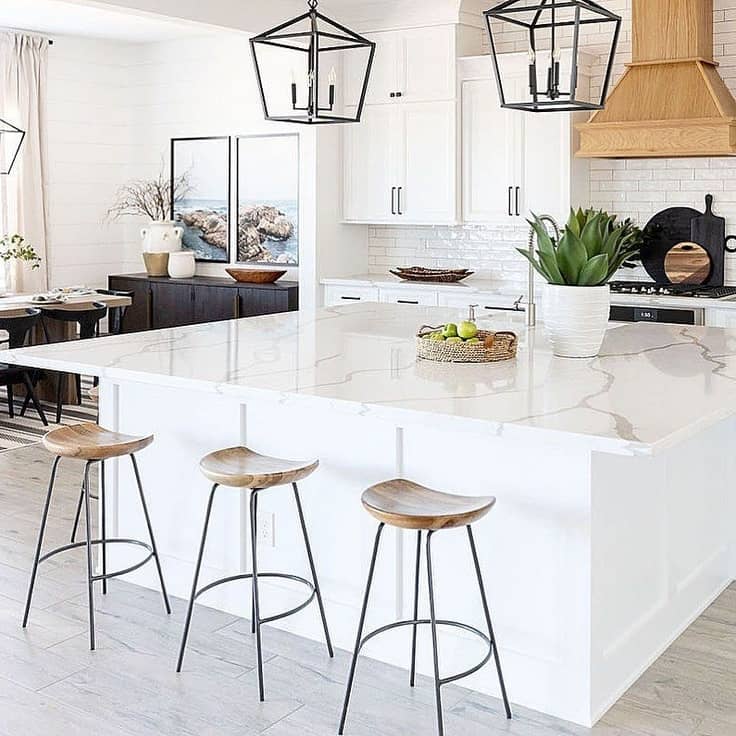 white marble island and antique white cabinets