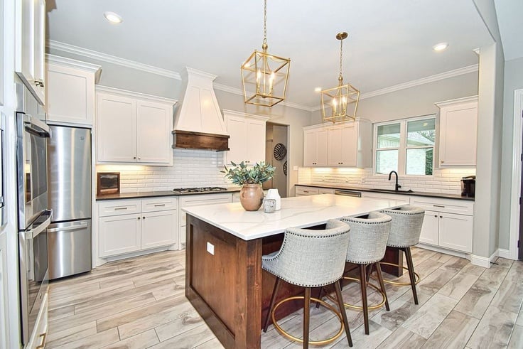 toque white kitchen cabinets with wood accents and stained wood island