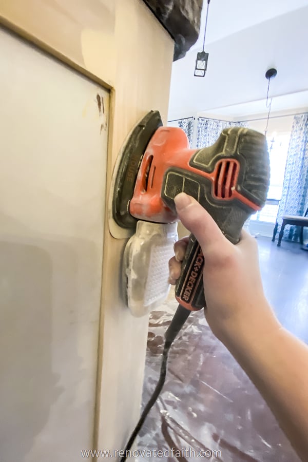 orange sander sanding cabinets