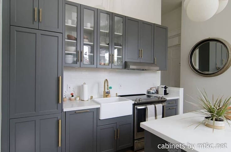 dark gray kitchen with white backsplash and counters