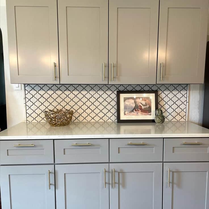 gray cabinets and tile backsplash