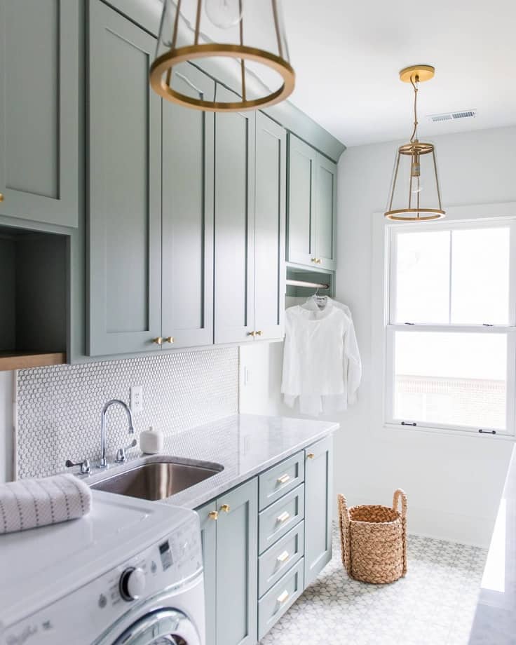 mid tone green laundry room cabinets