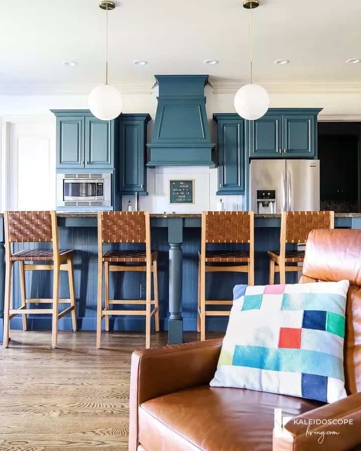 blue kitchen cabinets with white backsplash