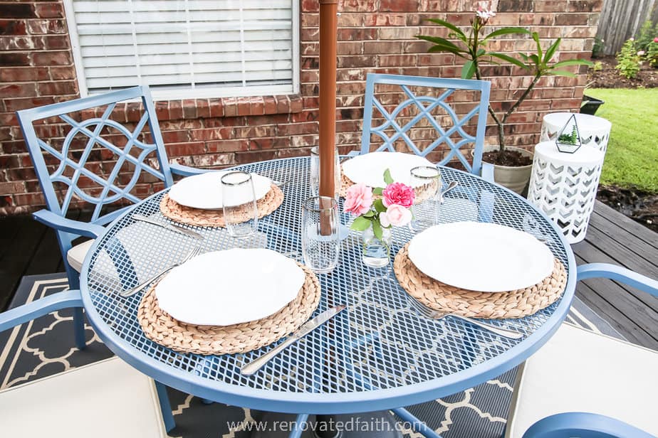 top of blue patio table with plate settings