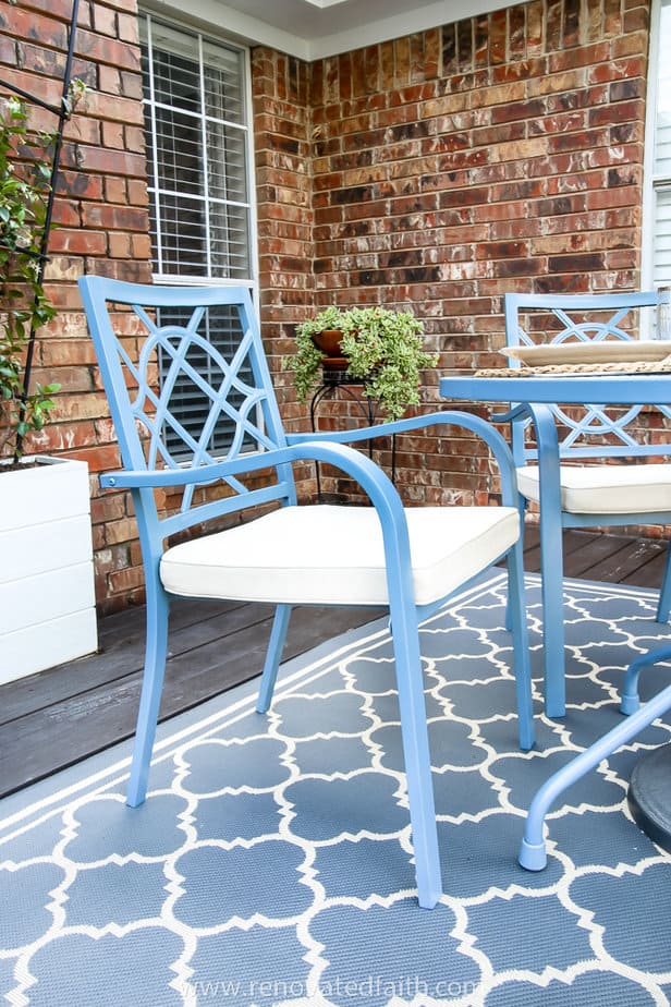 blue chair on patio and potted plants