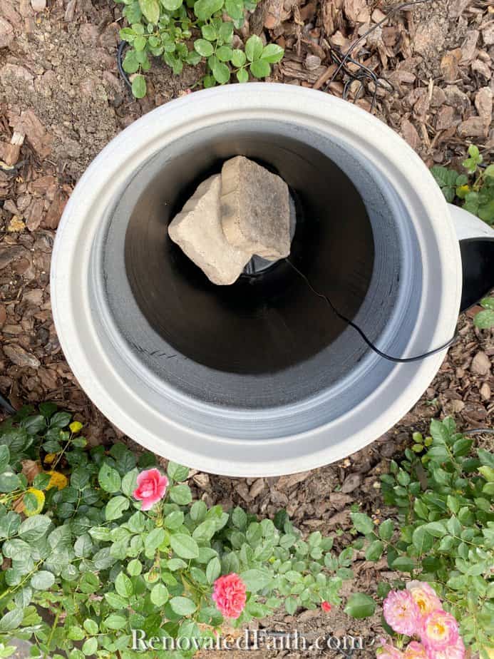 bricks inside a water fountain planter