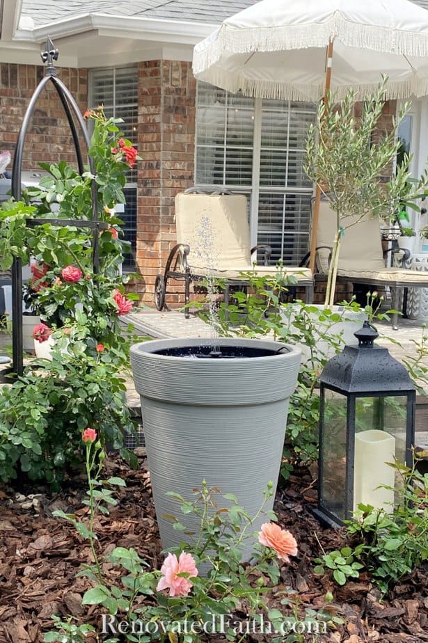 water fountain in front of deck and umbrella