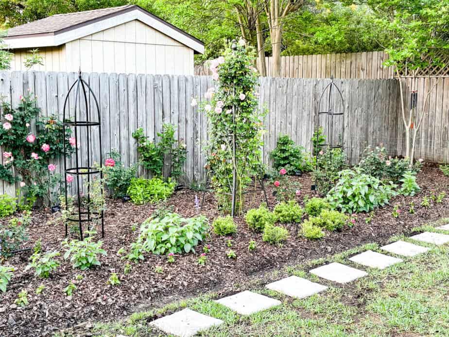 plastic stepping stones in front of flower bed